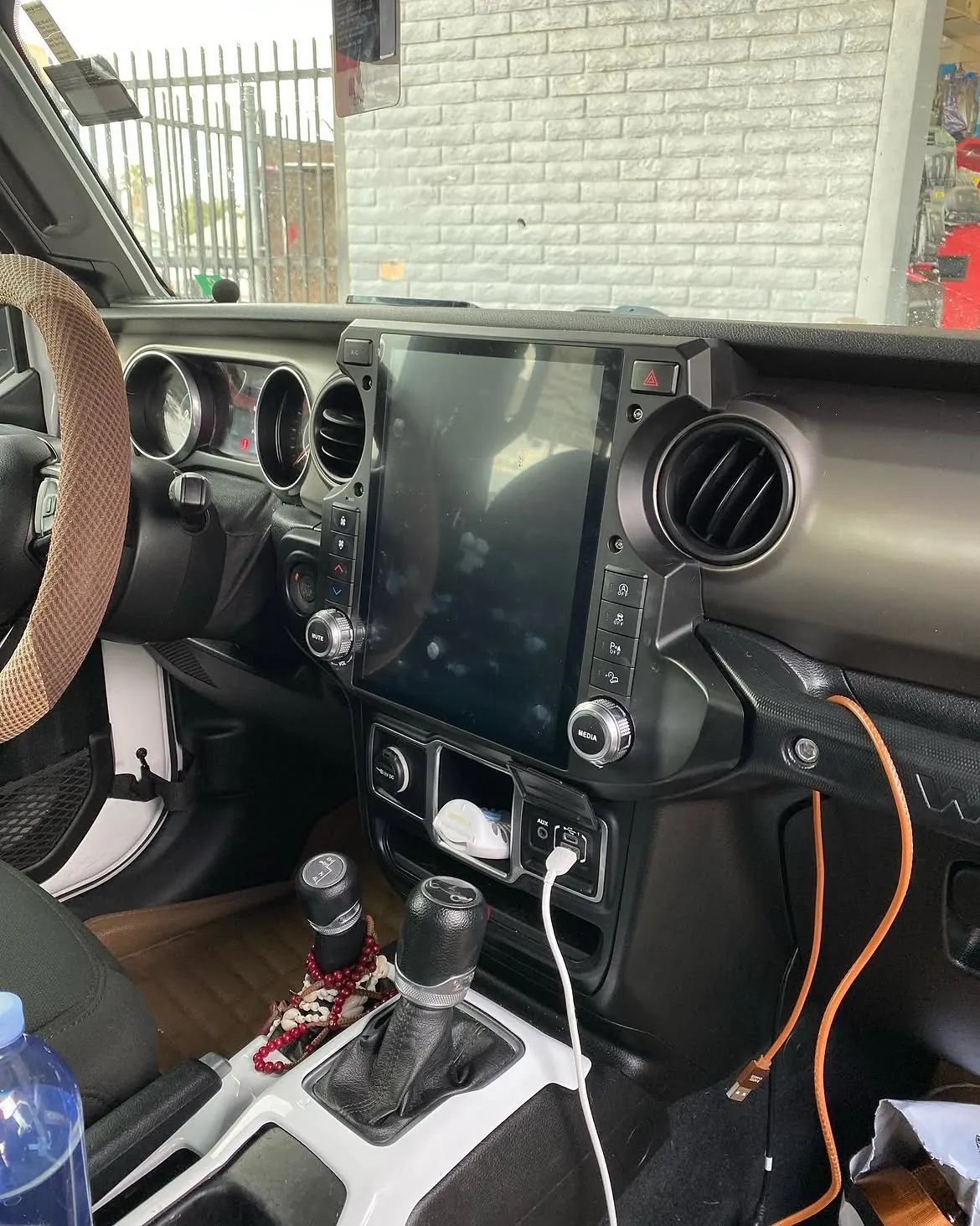 A large vertical touchscreen installed in a Jeep Wrangler dash